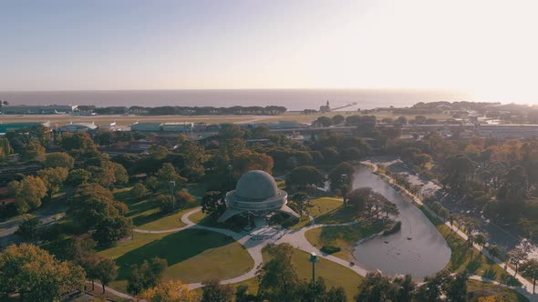 Aerial shot flying towards Galileo Galilei planetarium at sunrise in Buenos Aires alt
