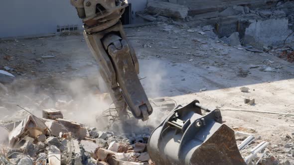 close up shot of an excavatoring debris at a demolition lot by the river. alt