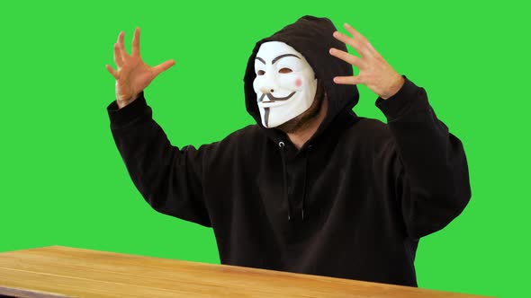 Crazy Hacker Terrorist in White Mask Intimidating of Cyber Internet Attack Hacking Criminal Warning