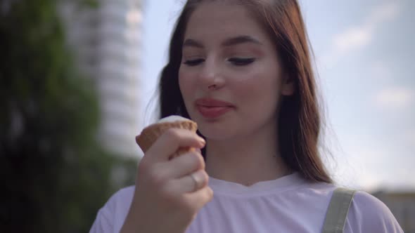 Happy Smiling Woman Eating Vanilla Ice Cream Looking at Camera Close Up Face