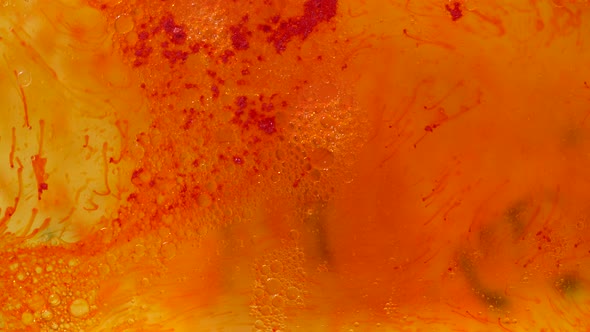 Yellow And Red Oil Texture With Bubbles Floats On Water