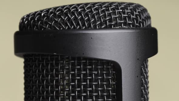 Studio Condenser Microphone Rotates on Yellow Background with Place for Text alt