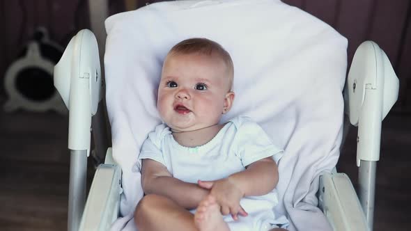 Cute Little Newborn Girl with Smiling Face Looking at Camera on White Background alt