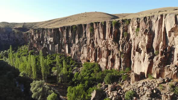 Aerial Deep Long Rift Canyon with Cleft Steep Rock Walls and High Cliff Gorge alt