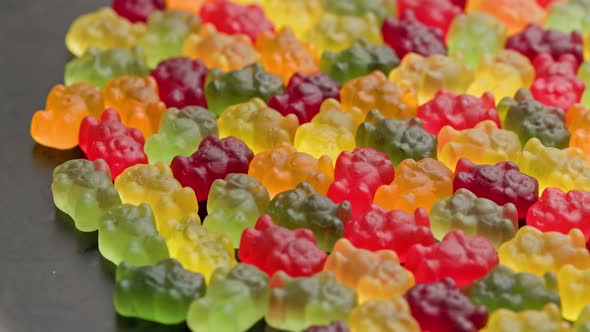 Full Frame Looped Spinning Background of Colorful Jelly Bear Candies alt