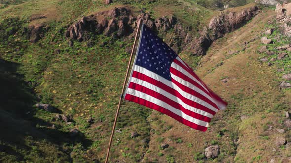 USA Flag on a Flagpole.  Aerial of the American Flag Is Fluttering on a Wind alt