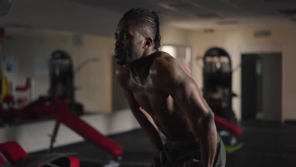 Live Camera Zoom in to Exhausted Satisfied African American Man Resting After Workout in Gym alt