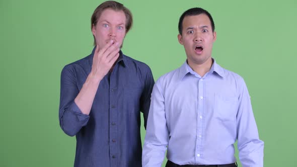 Two Stressed Multi Ethnic Businessmen Getting Bad News Together alt