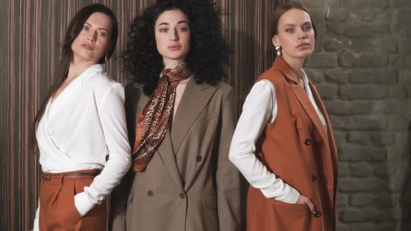 Three Beautiful Young Girls in Business Suits. Business Style.  alt