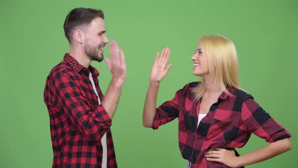 Young Couple Celebrating with Highfive Together
