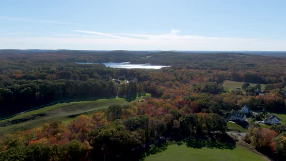 Autumn color forest and lake water reflection, town of Haverhill, USA. Aerial drone view alt