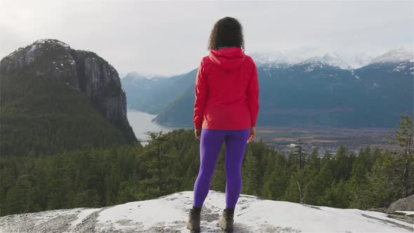 Adventurous Girl Hiking in the Mountains During a Sunny Autumn Sunset alt