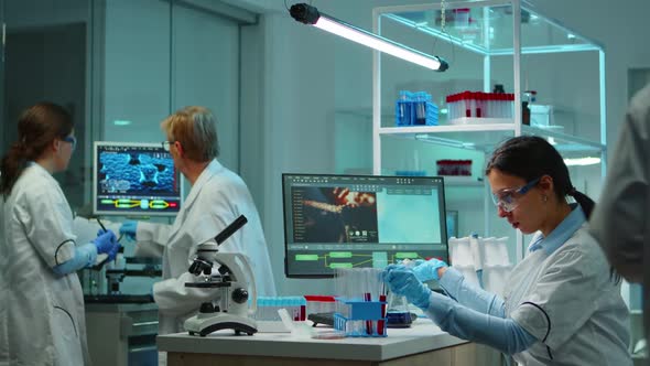 Scientist Woman Pipetting Liquid to Test Tube alt