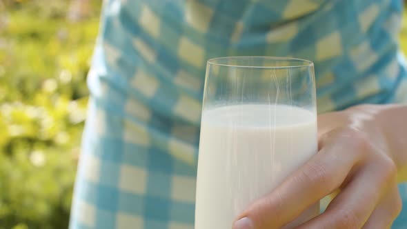 Glass of Milk in Female Hands alt
