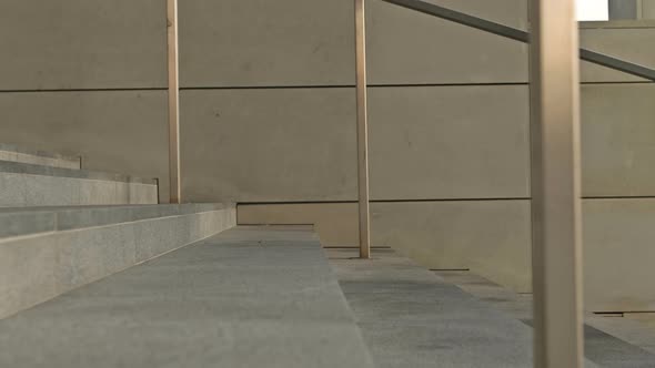 The Feet of Different People Go Down the Stairs of an Underpass or Subway in Different Ways alt