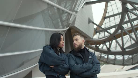 Man and woman looking at each other with attitude alt
