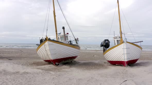 Old Fishing Boats Lined Up Ashore on Thorup Strand Beach in Denmark alt