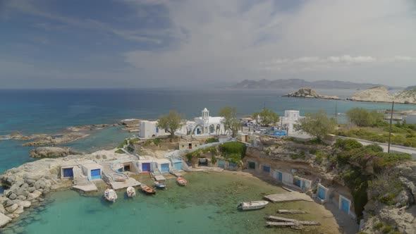 Slow Tilt Down of Boats Docked on the Fishing Village of Mandrakia in Milos alt