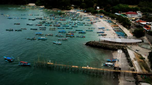 Aerial video of Pangandaran beach, West Java with fishing boats and white sand beaches