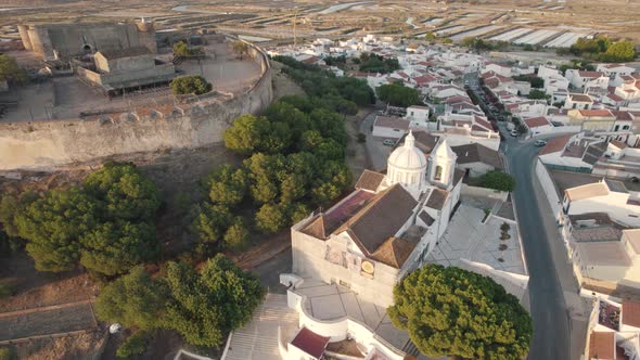 Pan right aerial shot around historical Church of Our Lady of Martyrs in Castro Marim, Algarve. alt