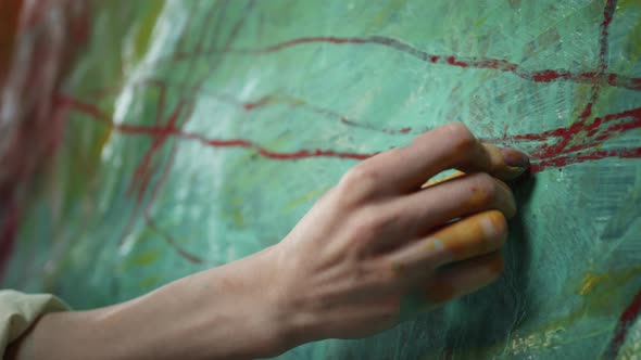 Female Hand Painting On Canvas. alt