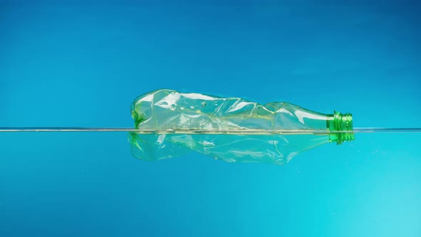 Floating Plastic Bottle in the Ocean Throwing Garbage Into the River or Lake Water Pollution alt