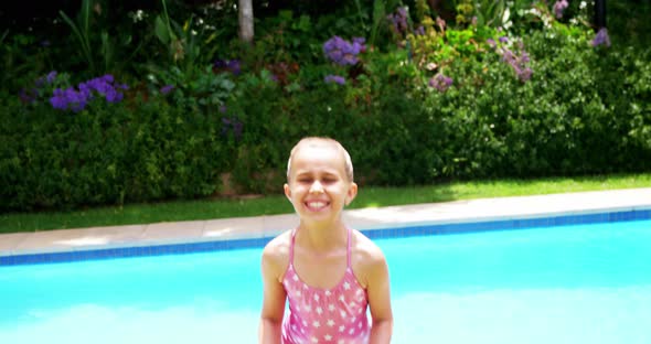 Girl jumping near swimming pool alt