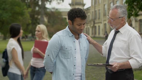 Literature Teacher Praising His Hispanic Student. Higher Education and Knowledge alt