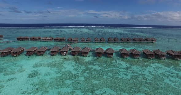 Aerial view of Maldives and luxurious over water villas. Luxury travel agency concept