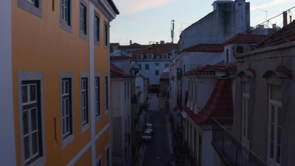 Backwards Flying Drone Camera Between Buildings in Evening Downtown alt