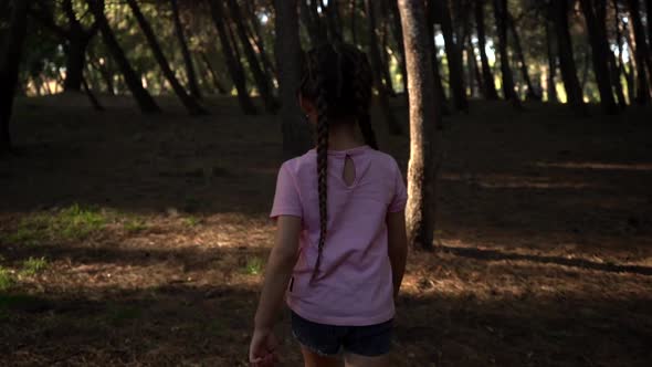 Girl Walking In The Woods