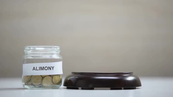Alimony Glass Jar With Coins on Table, Gavel Striking on Sound Block, Government alt