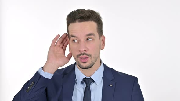 Portrait of Curious Young Businessman Listening Secret, White Background alt