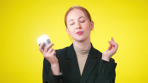 Thoughtful Redhead Slim Woman Standing at Yellow Background Thinking alt