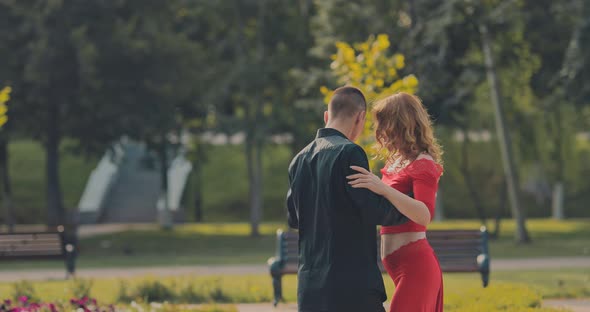 Beautiful Couple Rehearsing Dance Moves in the Park