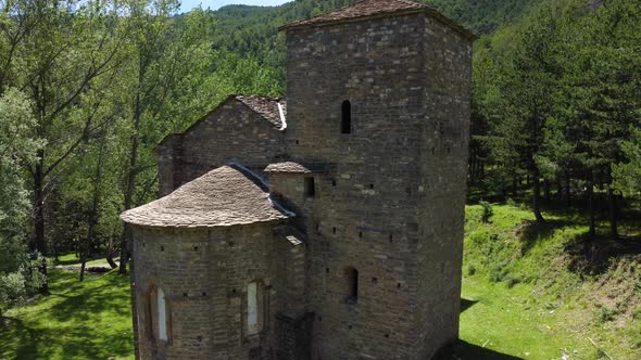 Circular drone view of a mountain church in the pyrenees alt