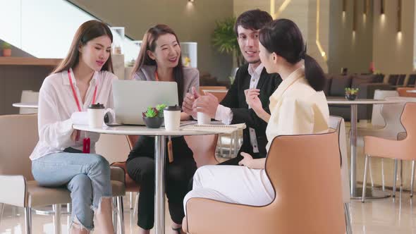 Businessmen and woman talking at meeting in modern design office with laptop alt