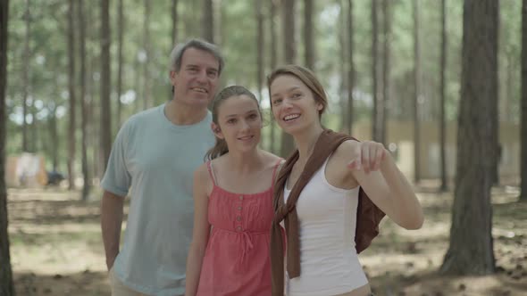 Parents and daughter exploring in woods
