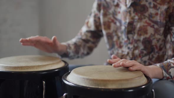 Closeup of Man Hands on African Drums. Man Playing on a Bongo Drum Close Up
