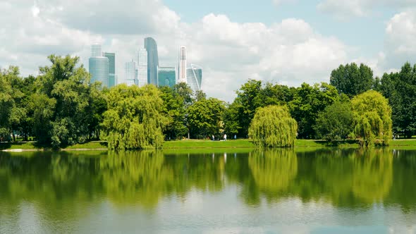 A Pond on the Background of City Skyscrapers