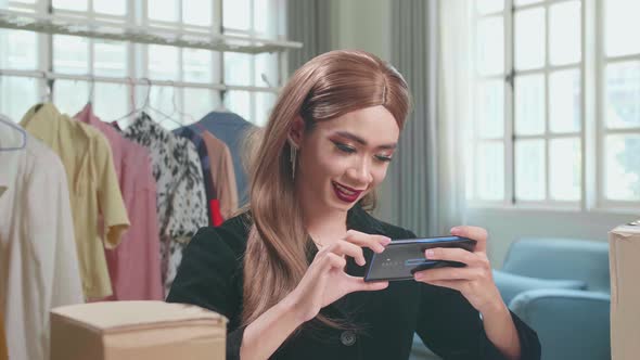 Asian Transgender Woman Business Owner With Boxes, Take Photos Of Product For Send To Customers alt