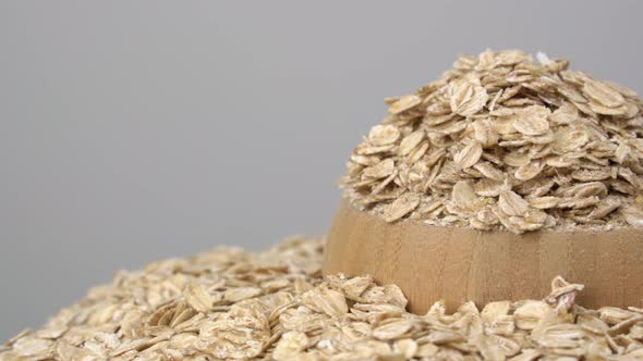 Organic products. Oatmeal on white background. Oat flakes in wooden bowl. alt