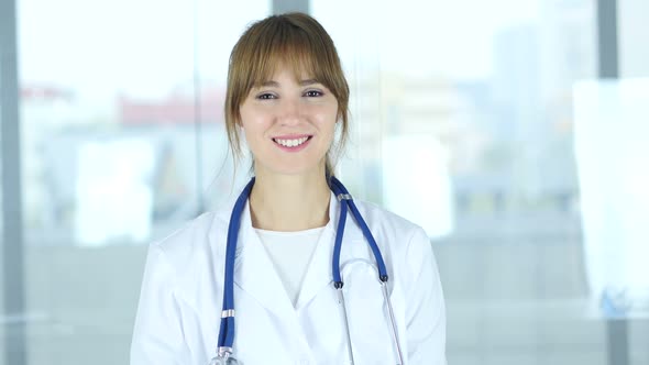 Portrait of Smiling Positive Female Doctor in Clinic alt