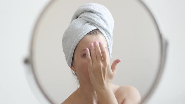 Woman applying liquid powder foundation on face skin 4K 2160p 30fps UltraHD footage - Female in fron