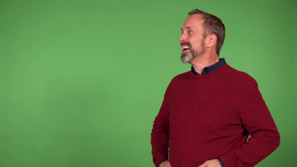 A Middleaged Handsome Caucasian Man is Excited and Laughs  Green Screen Background