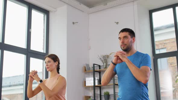 Happy Couple Exercising and Doing Squats at Home alt