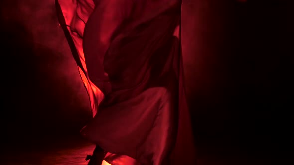 Dancer in the Rhythm of the Music Develops the Skirt. Llight From Behind. Smoke Background. Close Up alt