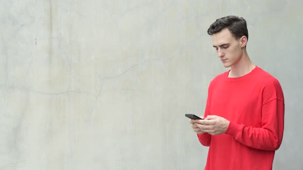 Young Happy Handsome Man Using Phone alt