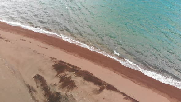drone aerial over tropical sandy beach passing over fishing village pump boats alt