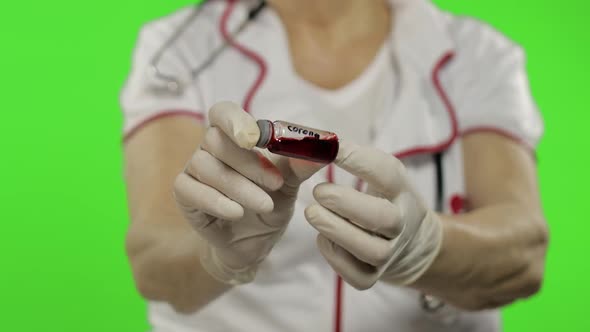 Hands of Elderly Female Doctor. Test Tube with Analyzes. Coronavirus. Covid-19 alt